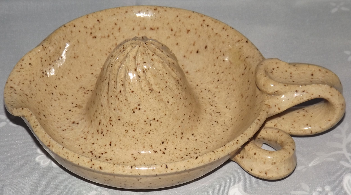 Pottery juicer with loop handle and hanging loop