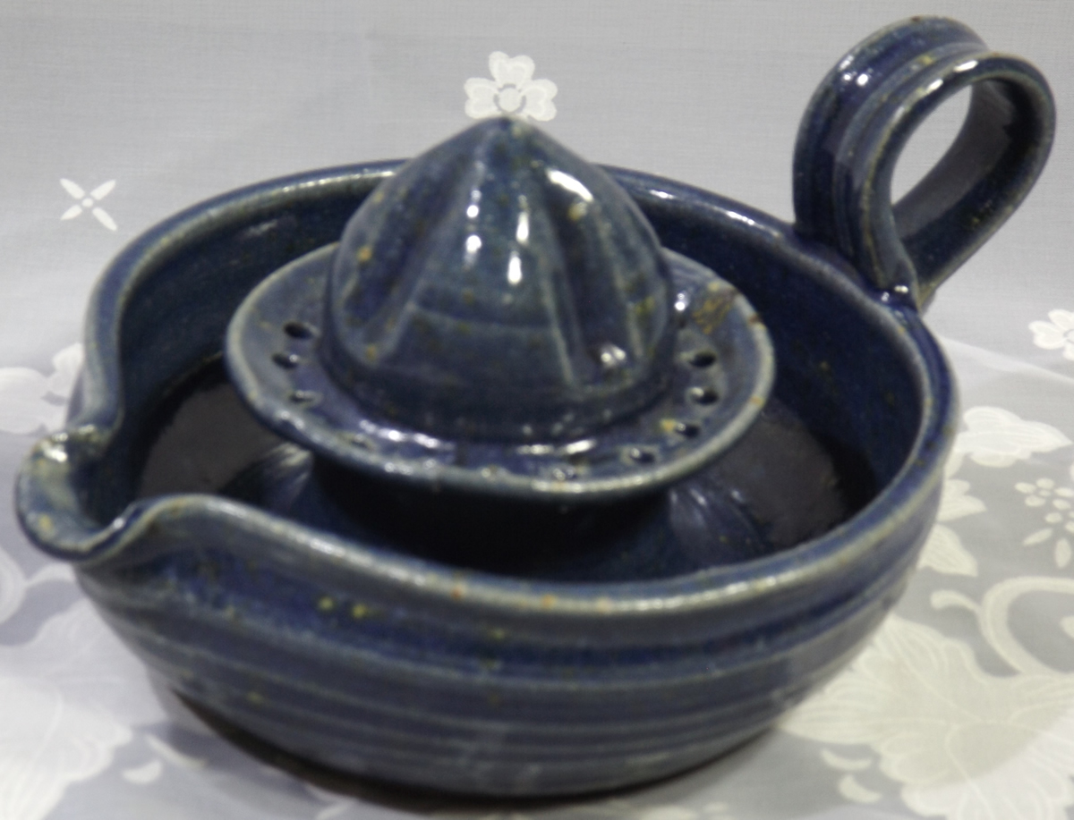 Blue loop handle pottery juicer with strainer
