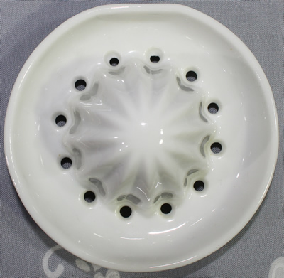 Reamer for oranges on orange & white ceramic juicer