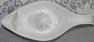 Top view a white 'gravy jug' like ceramic juicer 