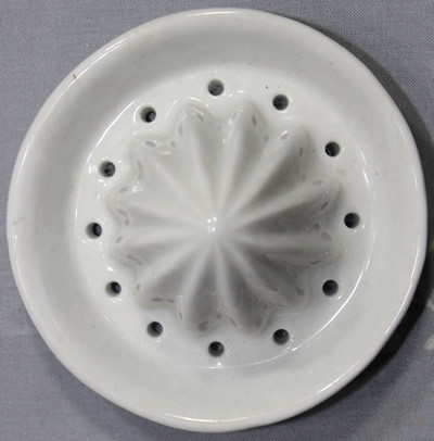 The reamer for a small 2 piece blue on white pagodas teapot juicer