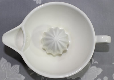 Top view of a white 'Juicer cup with bamboo base'