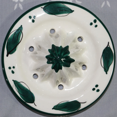 Reamer for green flowers on white ceramic jug juicer