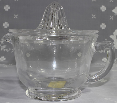 Side view of a modern Anchor Hocking 2 piece clear glass juicer