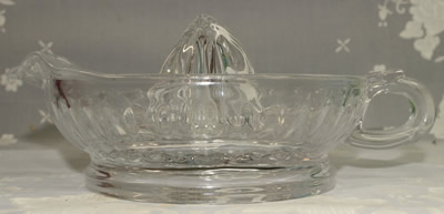 Side view of a Morgan & Finch Home Collection clear glass loop handle juicer