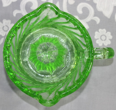 Top view of a modern green glass 1 piece twisted juicer