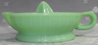 Side view of a reproduction jadeite glass jug like juicer