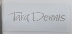 The brand label on a 2 piece Tara Dennis white milk glass juicer 