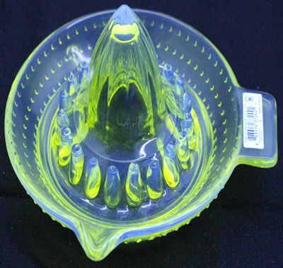 An ARC 'Crazy Colors Yellow' glass juicer under UV light