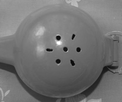 The hole pattern on an orange Supreme Houseware and Gifts metal 'Orange Squeezer' juicer