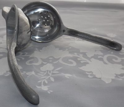 An open hinged cast aluminium squeezer showing drain holes