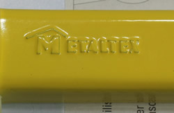 The embossed Metaltex on a hinged yellow aluminium hand held squeezer