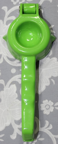 The base of a green die cast aluminium hand held lime squeezer 