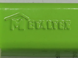 The embossed Metaltex on a hinged green aluminium hand held squeezer 
