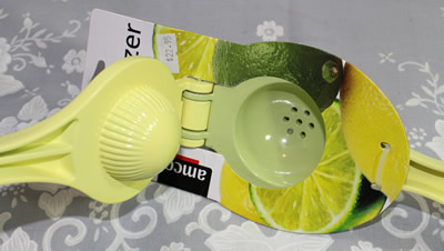 An open Amco Houseworks yellow and green squeezer juicer