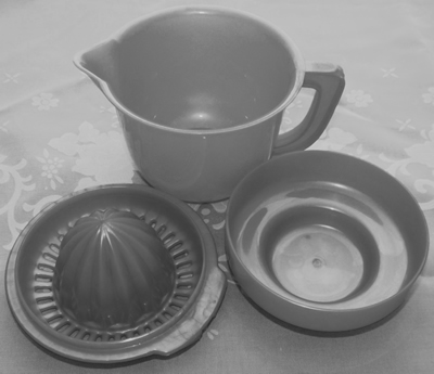 3 parts of plastic juicer on jug with lid
