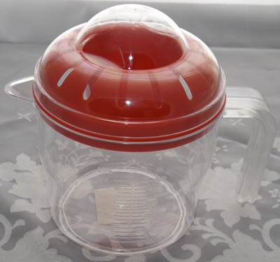 Red & clear plastic 2 piece juicer closed