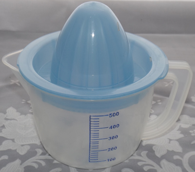 Blue and translucent white plastic juicer closed
