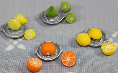 4 different fruits on miniature juicer