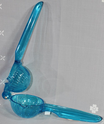 An open Quality & Classic hinged blue plastic hand held squeezer 