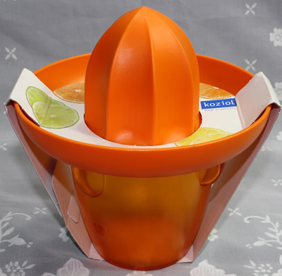 A packaged orange Koziol 'Pedro' plastic juicer