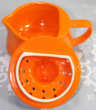 Showing the truncation for an orange Japanese ceramic 2 piece juicer