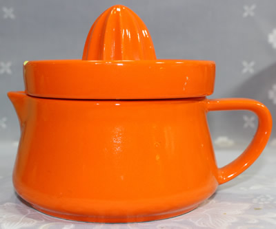 The profile of an orange Japanese ceramic 2 piece juicer