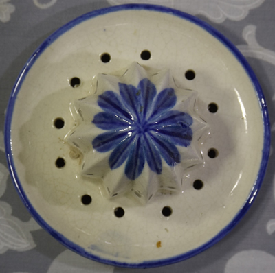The reamer for a blue grapes and leaves on white juicer