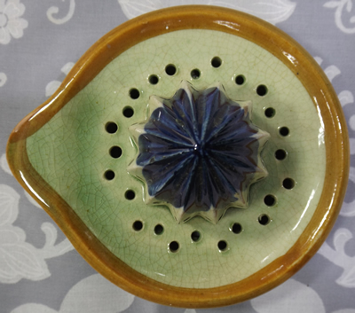 The reamer with a pouring spout for a blue flowers on tall green juicer