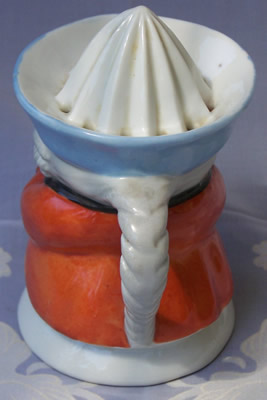 Back view of an orange with blue hat black collar1 piece toby juicer