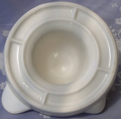 Base of a large white saucer shape spiral cone ceramic juicer