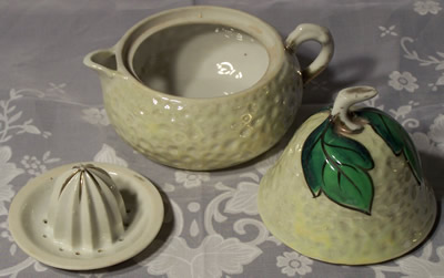 The 3 parts of a greenish white pear juicer