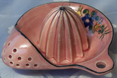 Alternate view of a pink with multicoloured flowers hanging strainer juicer
