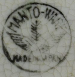 A Manto Ware (Manto-Ware) basemark on a green and white duck juicer
