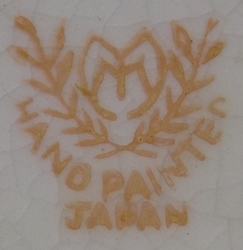 Black & orange crosses on juicer base mark