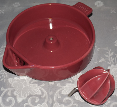 Parts of a maroon Wolverine Products juicer