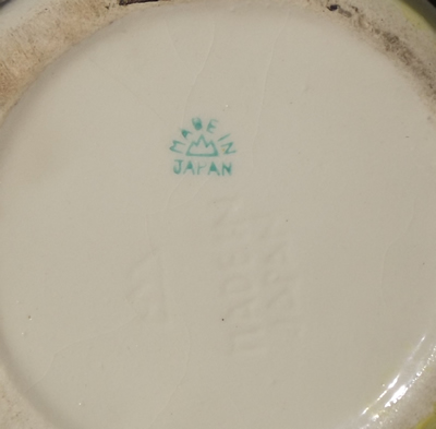 Incised markings on base on pale green clown juicer