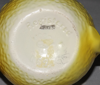 The base of a yellow Goebel 'Orange for Baby' juicer