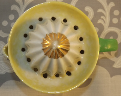Yellow and white with gold tip juicer top view