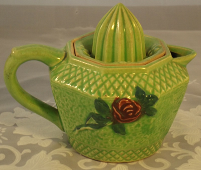 Back view of Green ceramic with deep red flowers juicer
