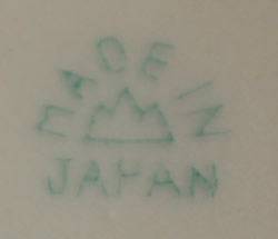 The basemark for a blue and white with pink, orange and yellow clown juicer