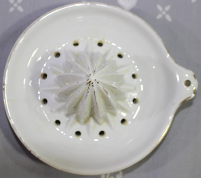 White ceramic juicer showing grip on reamer