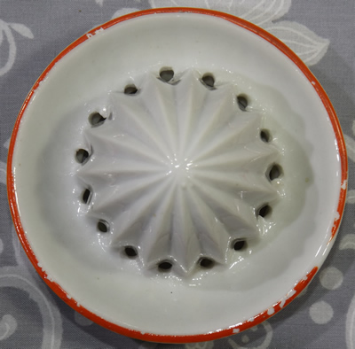 Reamer for a grey dog with white juicer with red trim