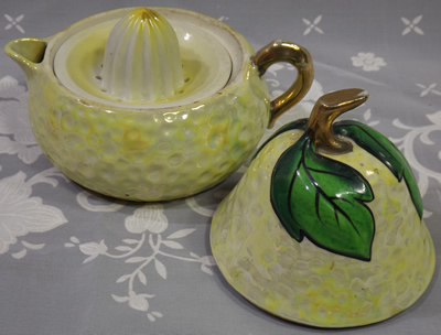 3 parts of Cream with yellow highlights and green pear shape juicer