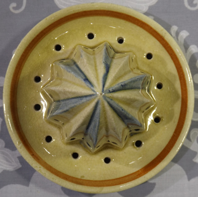 Reamer for a large cream 2 piece juicer with red and yellow flower