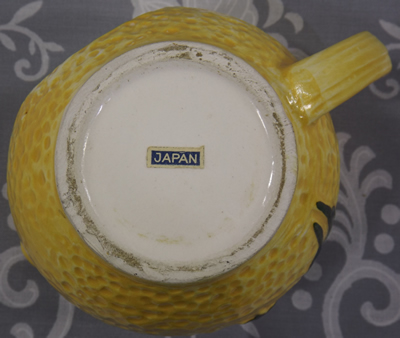 Base of Yellow Florida juicer with clown reamer