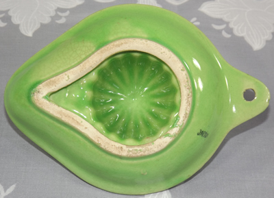 Base of lime green hanging strainer juicer