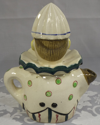 Back view of a 7¼" white clown with striped pants and maroon vest juicer