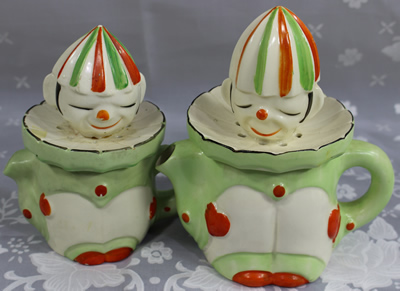 2 sizes of green on white clown with orange and green hat juicer