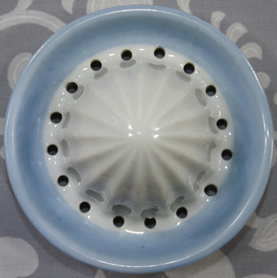 The reamer for a Limoges white and blue juicer with skier and car